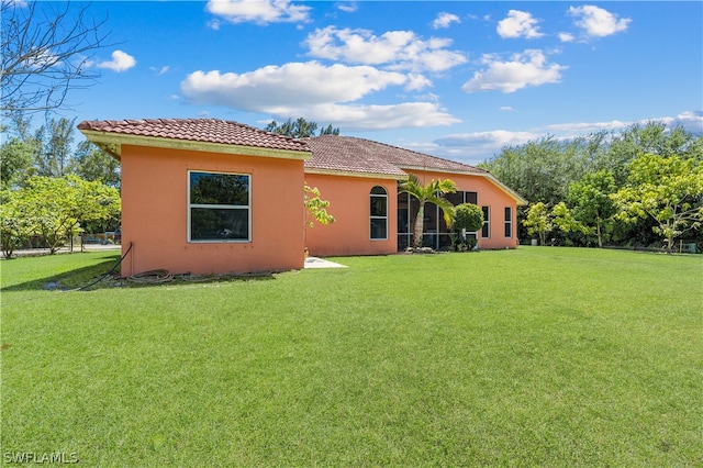 back of property featuring a yard