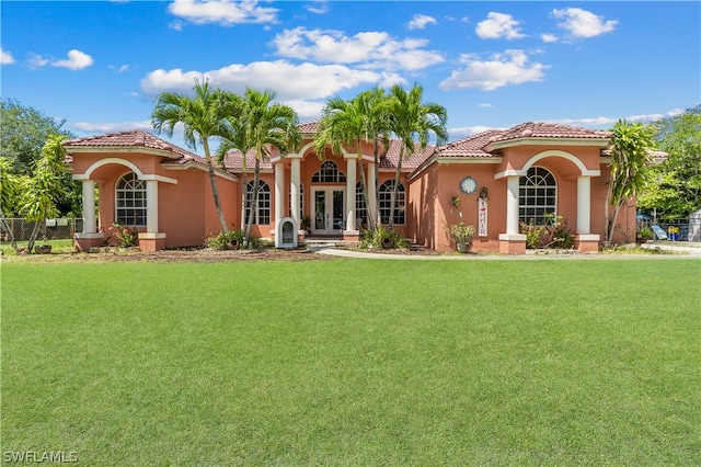 mediterranean / spanish house featuring a front lawn