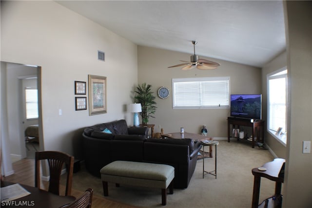 carpeted living room featuring ceiling fan and lofted ceiling