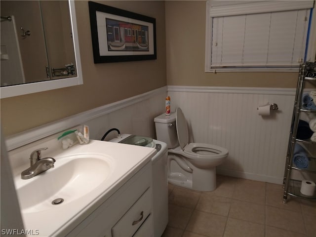 bathroom featuring vanity, toilet, and tile flooring