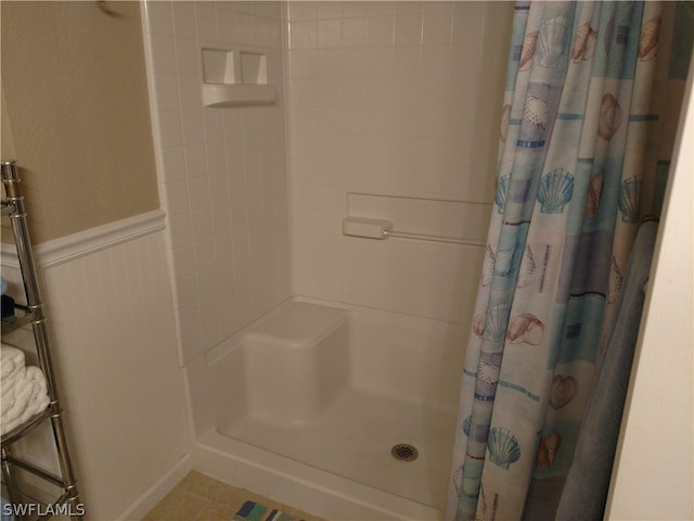 bathroom featuring tile flooring and a shower with shower curtain