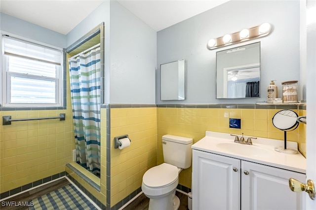 bathroom featuring vanity, a shower with curtain, tile walls, and toilet