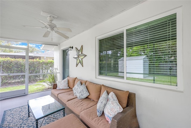 sunroom / solarium featuring a healthy amount of sunlight and ceiling fan