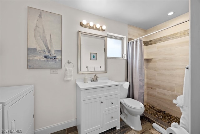 bathroom featuring a shower with shower curtain, toilet, washer / dryer, and oversized vanity