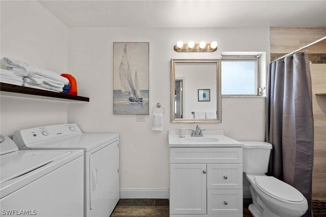 interior space with separate washer and dryer, tile flooring, toilet, and vanity with extensive cabinet space