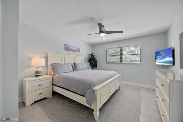 bedroom with ceiling fan and light tile floors