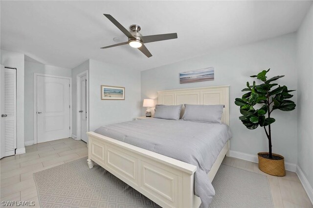 tiled bedroom featuring ceiling fan