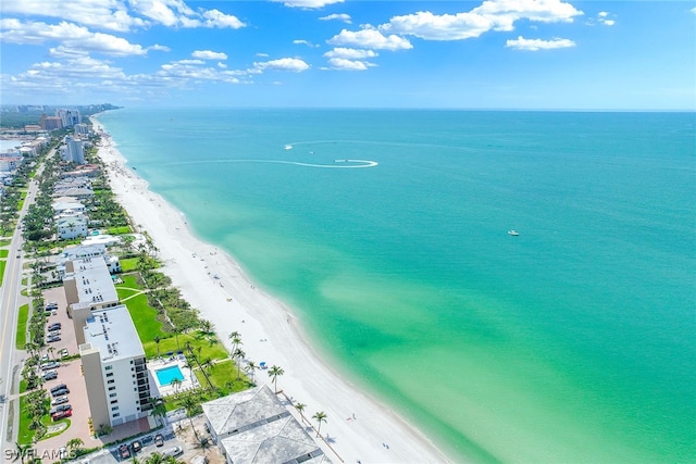 birds eye view of property featuring a beach view and a water view