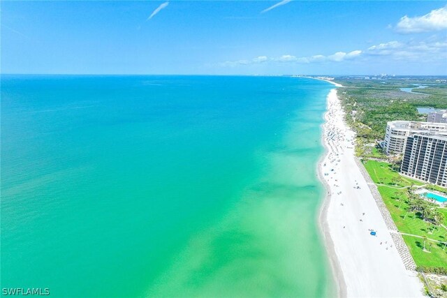 birds eye view of property featuring a beach view and a water view