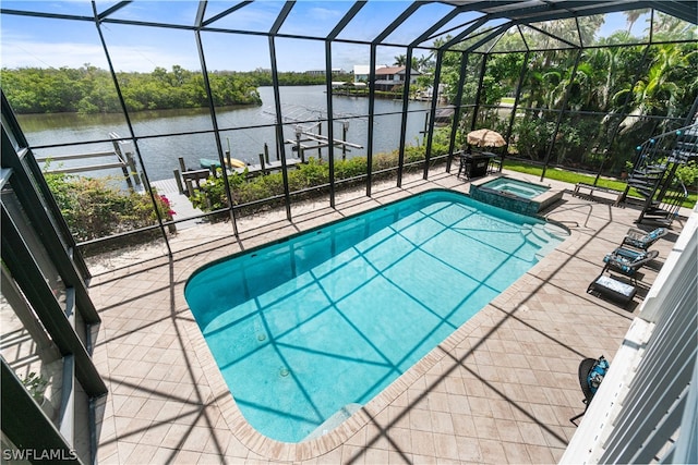 view of pool featuring a patio area, a lanai, an in ground hot tub, and a water view