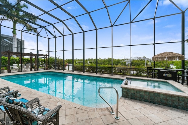 view of swimming pool featuring a patio area, a lanai, and an in ground hot tub