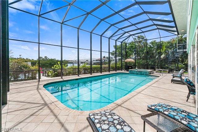 view of swimming pool with glass enclosure, an in ground hot tub, and a patio