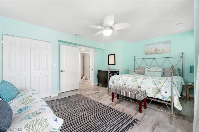 bedroom featuring a closet, wood-type flooring, and ceiling fan