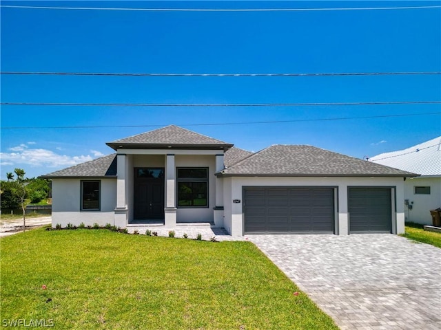 prairie-style house with a garage and a front lawn