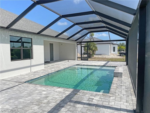 view of pool featuring a lanai and a patio