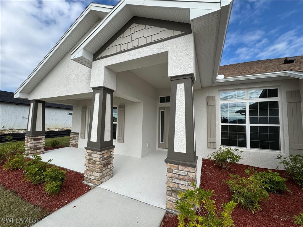 view of exterior entry with a porch