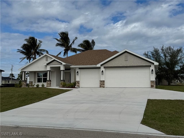 view of front of property featuring a front yard and a garage