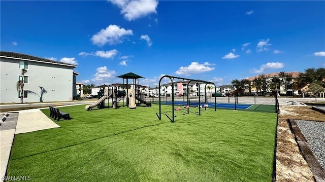 view of playground with a lawn