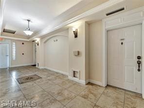 entryway with a tray ceiling