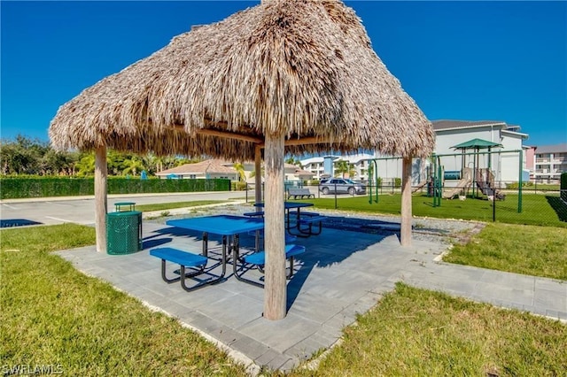 exterior space featuring a gazebo, a lawn, and a playground