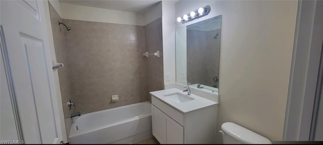 full bathroom with vanity, toilet, and tiled shower / bath