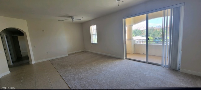 carpeted spare room with ceiling fan