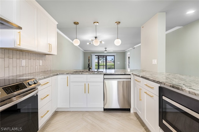 kitchen with backsplash, crown molding, appliances with stainless steel finishes, and white cabinets