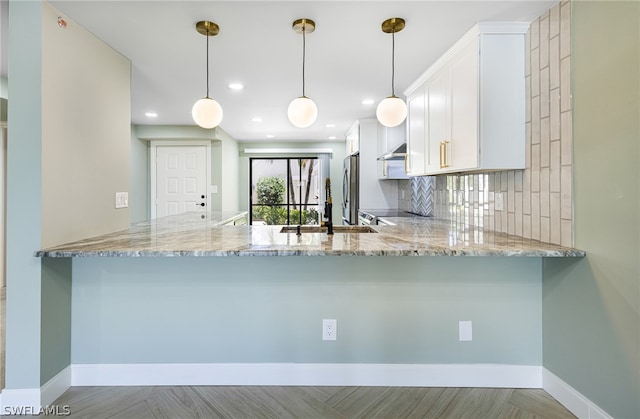 kitchen with kitchen peninsula and white cabinetry