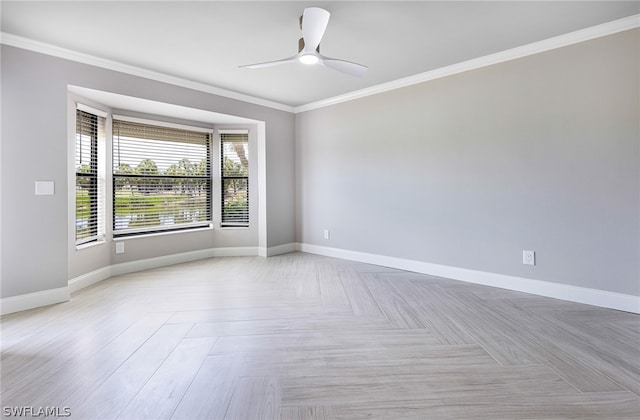 spare room with ceiling fan, light parquet floors, and crown molding