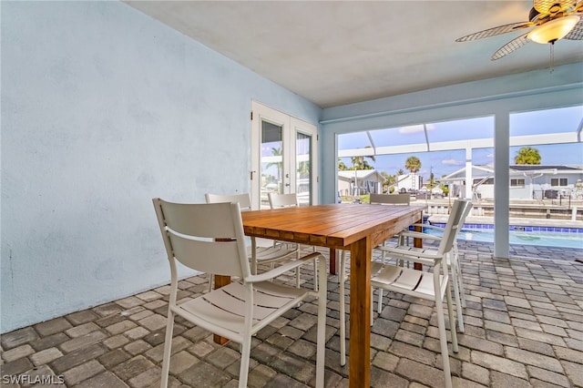 unfurnished dining area featuring ceiling fan and french doors