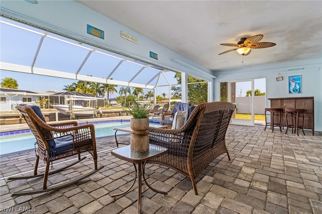 sunroom / solarium featuring ceiling fan