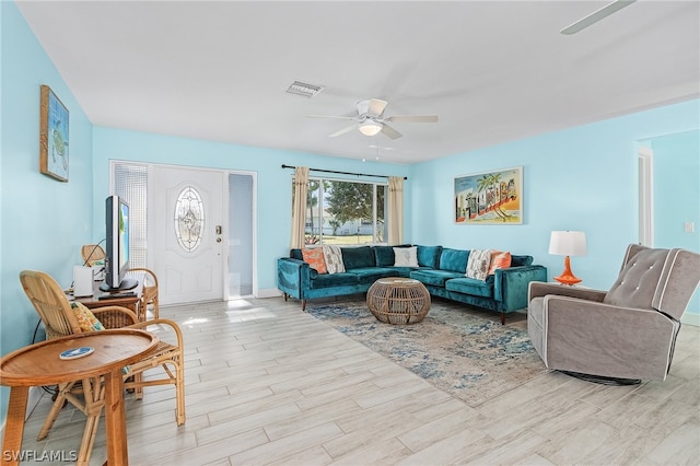 living room with ceiling fan and light hardwood / wood-style floors