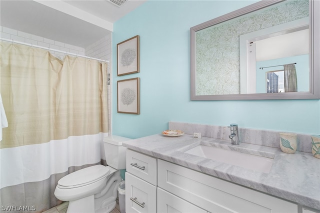 bathroom with large vanity and toilet