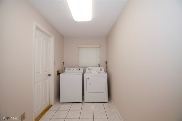 laundry room with separate washer and dryer, hookup for a washing machine, and light tile floors