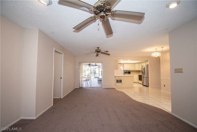 unfurnished living room with light colored carpet, a textured ceiling, and ceiling fan