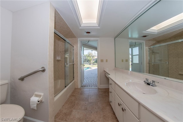 full bathroom with large vanity, toilet, enclosed tub / shower combo, and tile flooring