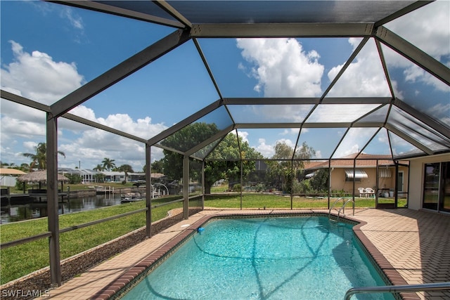 view of pool featuring a water view, a boat dock, glass enclosure, and a lawn