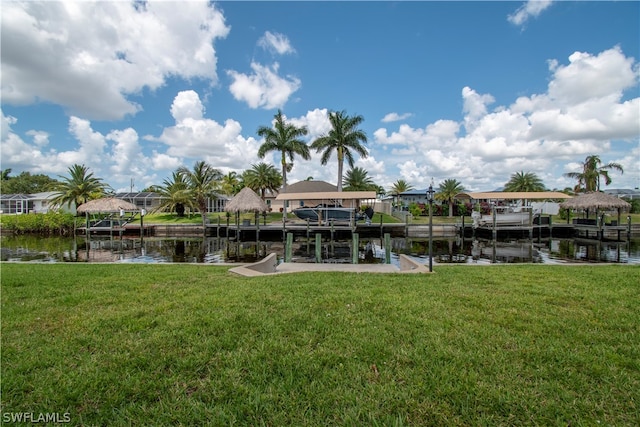 dock area with a water view and a lawn