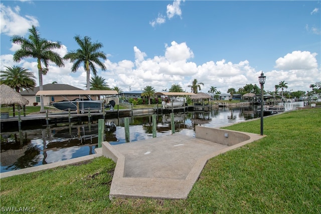 view of dock with a water view and a yard