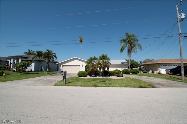 ranch-style house with a garage and a front lawn