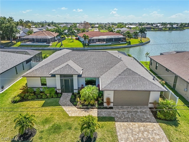 view of front of house featuring a water view, a front lawn, and a garage