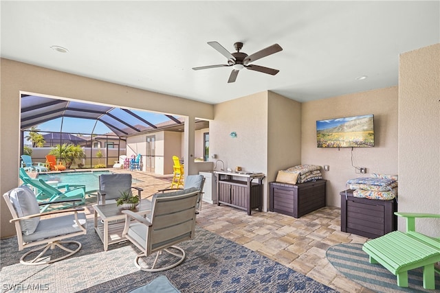 view of patio / terrace with ceiling fan and a lanai