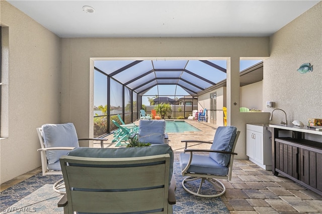 view of terrace featuring glass enclosure and an outdoor kitchen