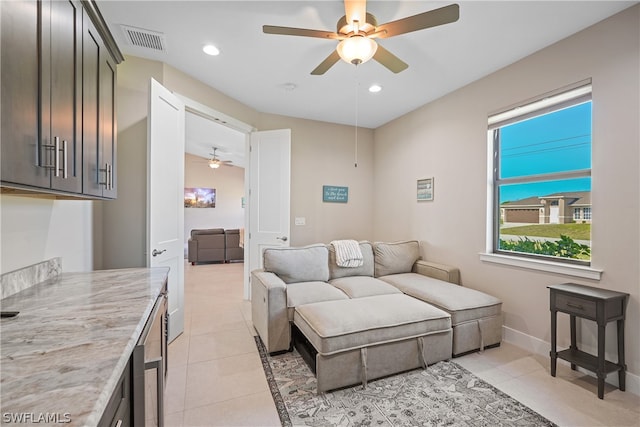 living room with ceiling fan and light tile flooring