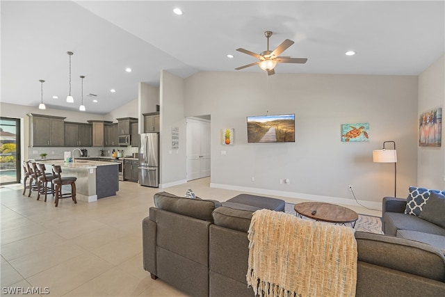 tiled living room featuring high vaulted ceiling, ceiling fan, and sink