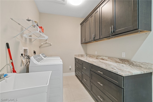 laundry room with light tile floors, cabinets, sink, hookup for a washing machine, and separate washer and dryer