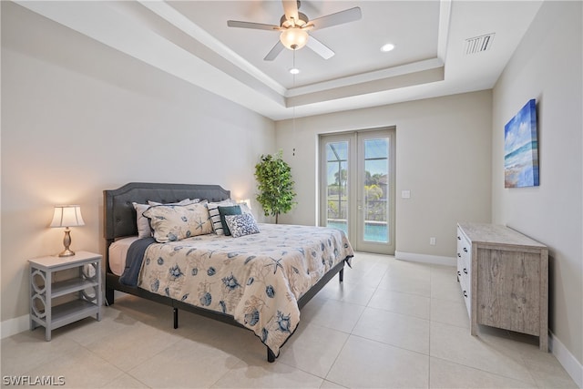 bedroom featuring french doors, access to exterior, light tile floors, a raised ceiling, and ceiling fan