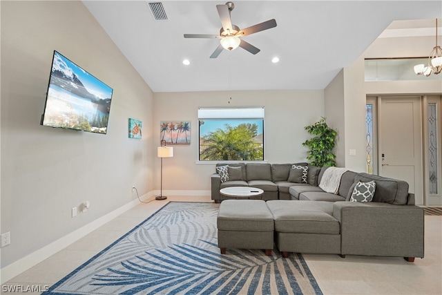 tiled living room with ceiling fan with notable chandelier and lofted ceiling