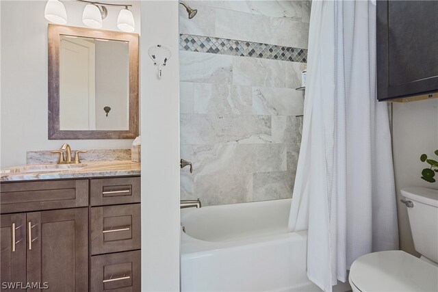 full bathroom with shower / tub combo, vanity, and toilet