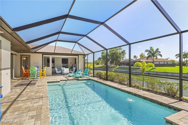 view of swimming pool with a patio, pool water feature, and glass enclosure